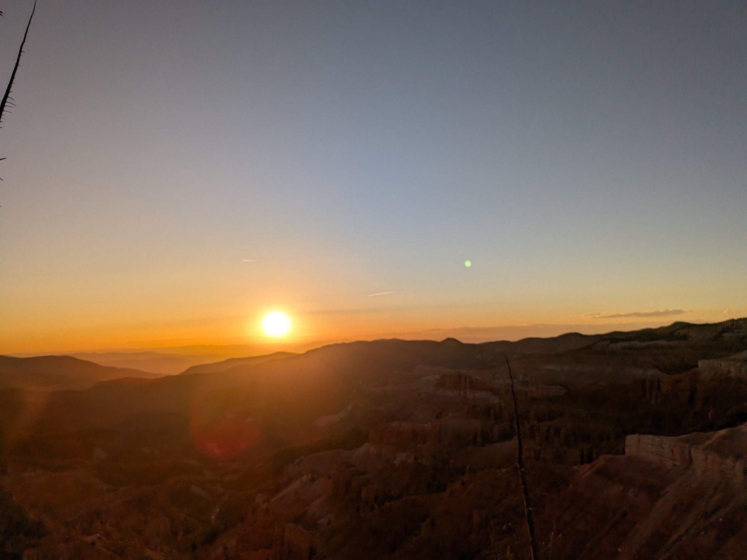 The sun setting behind the western ranges seen from the Cedar Breaks rim