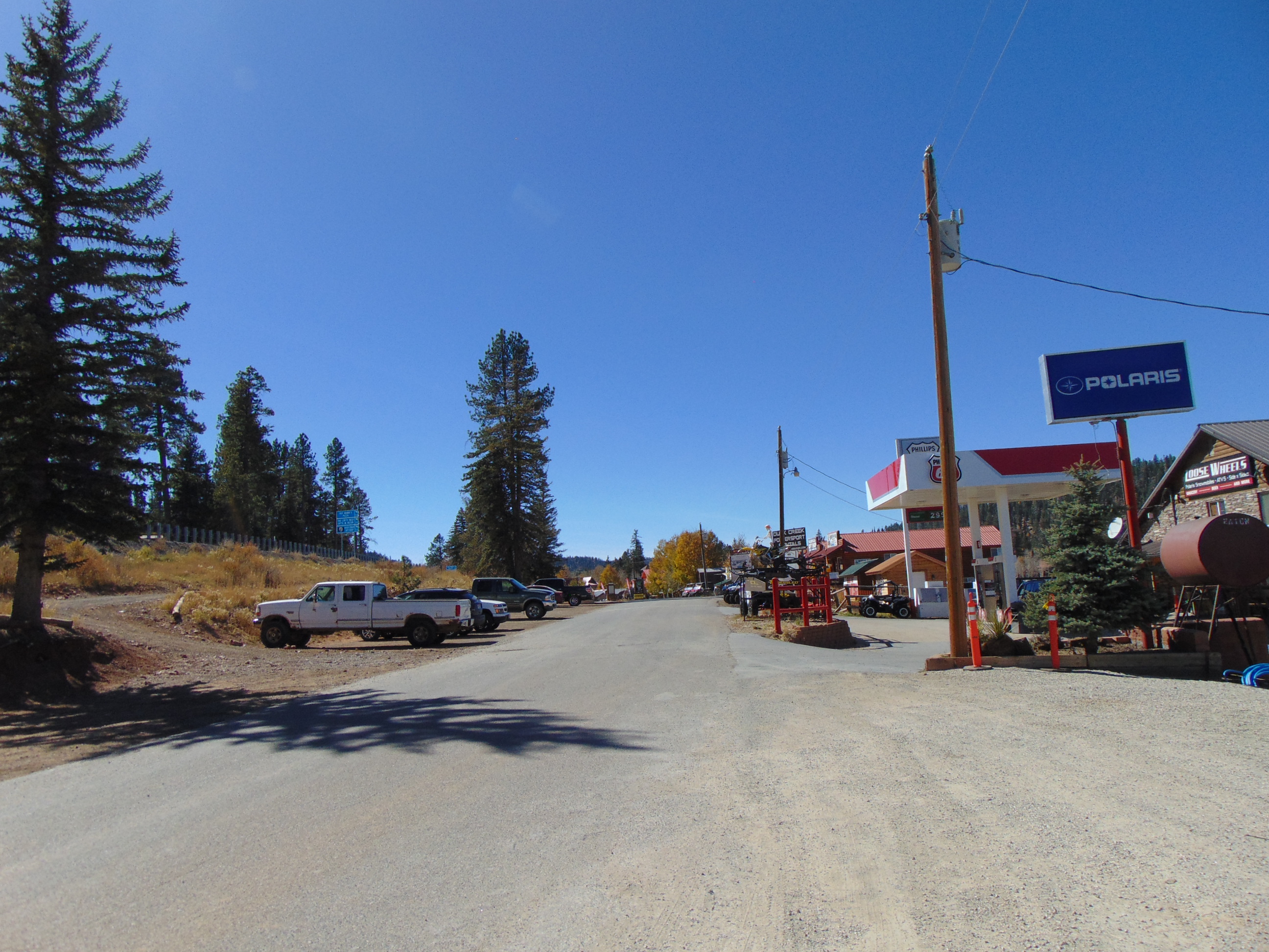 Movie Ranch Road looking west through Duck Creek Village, Utah, with forest beyond