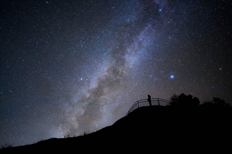 A silhouetted person at the Sunrise Point railing under the Milky Way (NPS photo by Keith Moore)