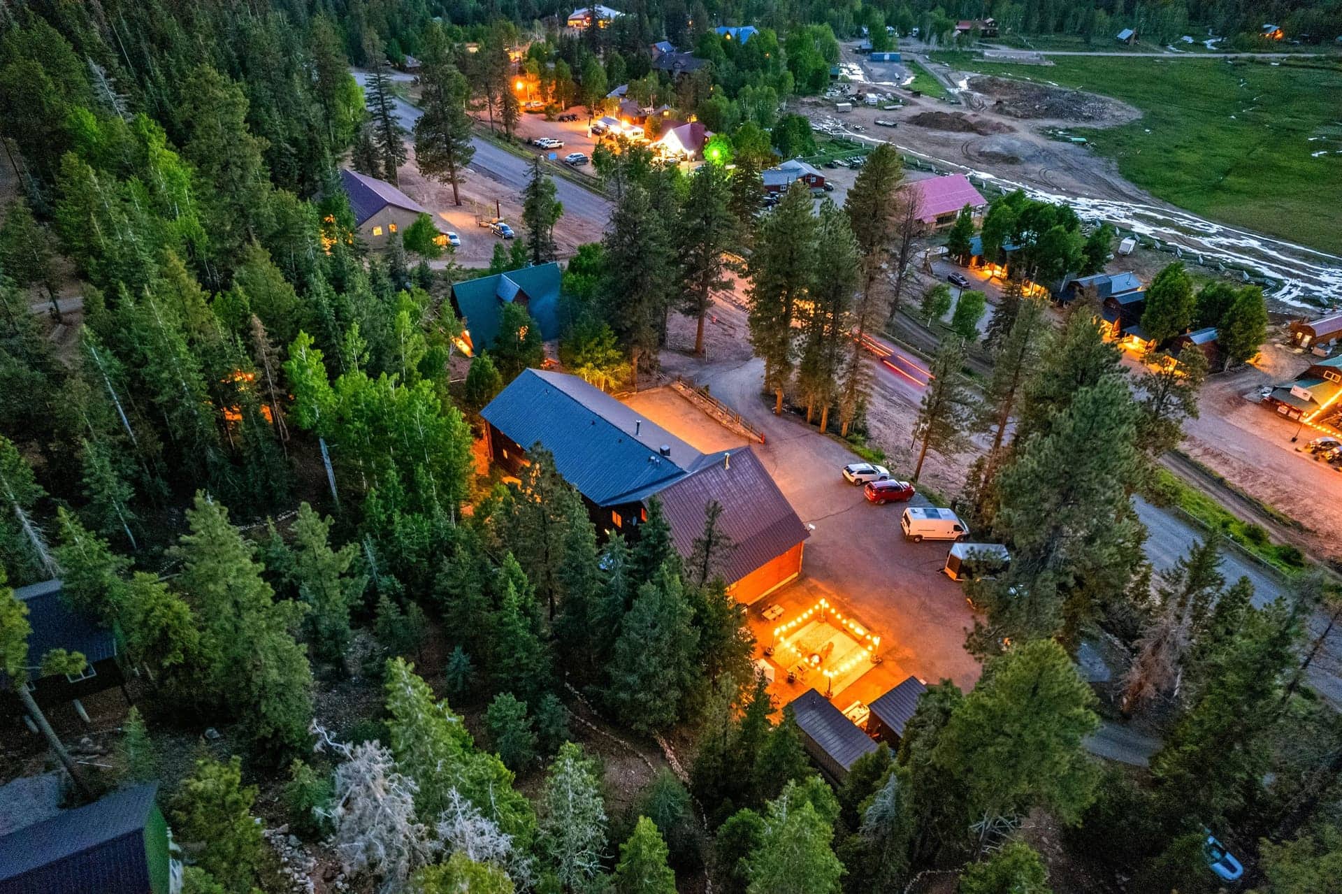 Aerial view of Duck Creek Village Inn and surrounding cabins at twilight