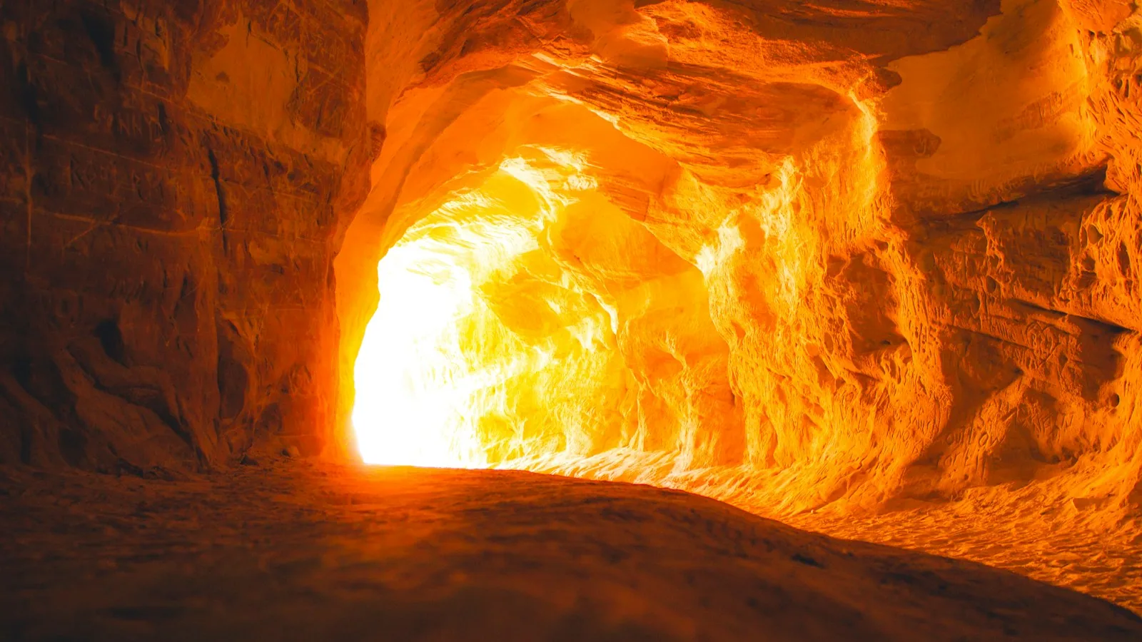 Light at the far end of a rippled sandstone tunnel, the Belly of the Dragon culvert under US-89 near Mount Carmel Junction
