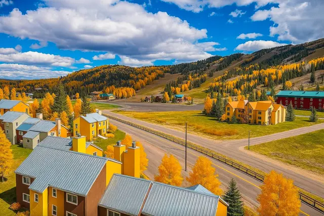 Aerial view of the condo complex in fall with the ski runs on the mountain behind
